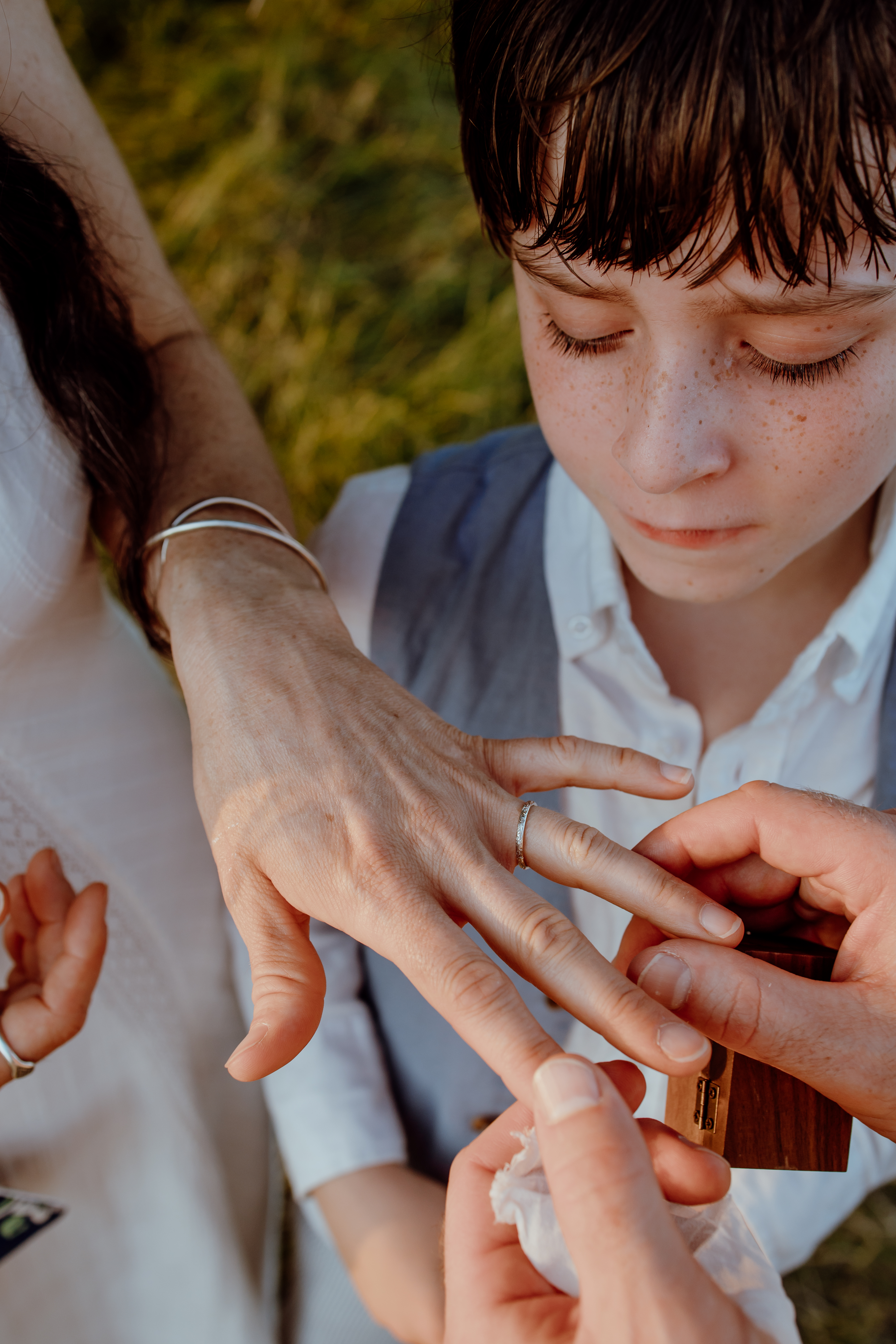Couple exchanging rings during a sunset vow renewal at Hill of Tara, Ireland